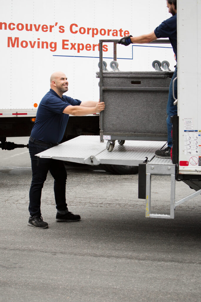 Man pushing cart into moving truck