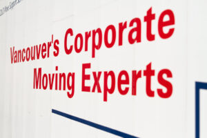Moving truck that reads "Vancouvers Corporate Moving Experts" on the side